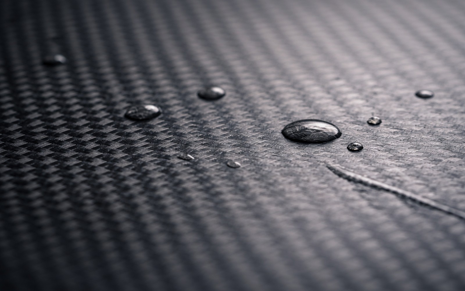 Surface behavior (water beads on carbon fiber)